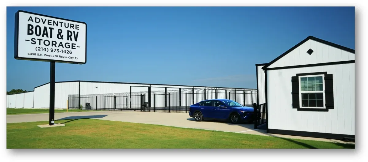 Secure gated entrance with facility sign and the front office.